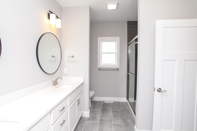 bathroom with tile patterned floors, toilet, an enclosed shower, and vanity