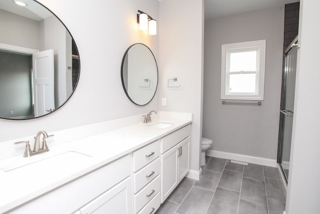 bathroom featuring tile patterned flooring, an enclosed shower, toilet, and dual vanity