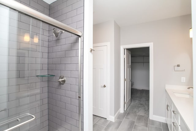 bathroom featuring a shower with shower door, tile patterned flooring, and vanity