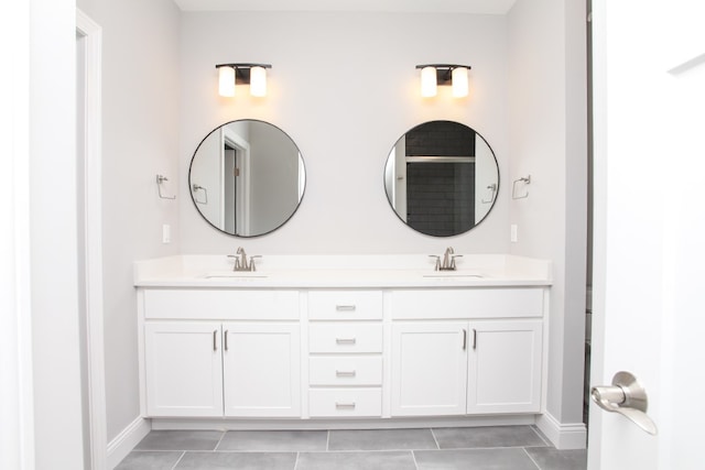 bathroom featuring tile patterned flooring and double sink vanity