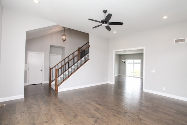 spare room with high vaulted ceiling, dark wood-type flooring, and ceiling fan with notable chandelier