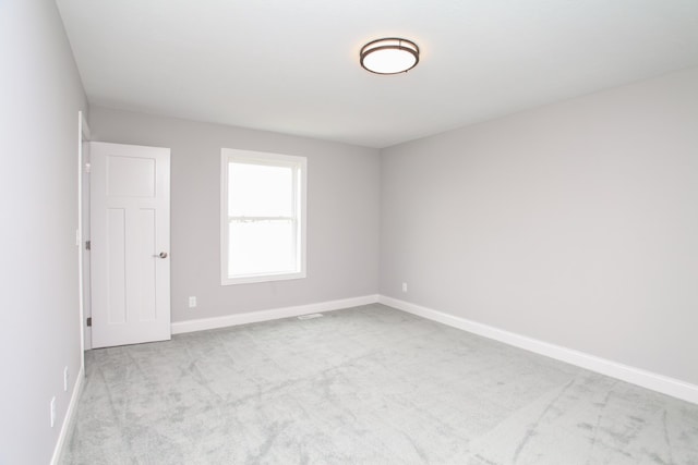 spare room with light carpet