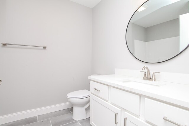 bathroom featuring tile patterned floors, vanity, and toilet