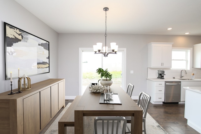 dining area featuring dark hardwood / wood-style floors, sink, and a chandelier