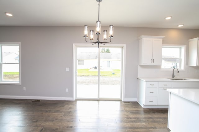 kitchen featuring a wealth of natural light, sink, dark hardwood / wood-style floors, and hanging light fixtures