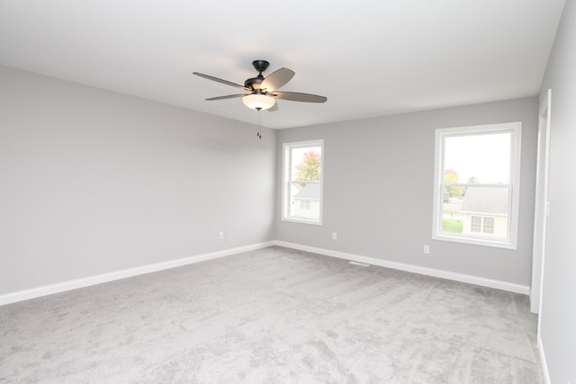 carpeted empty room featuring ceiling fan