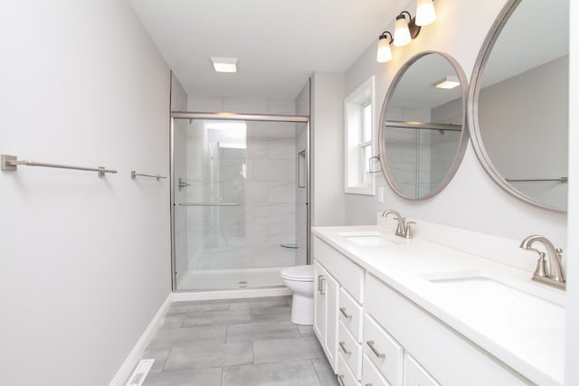 bathroom featuring dual vanity, tile patterned flooring, toilet, and a shower with shower door