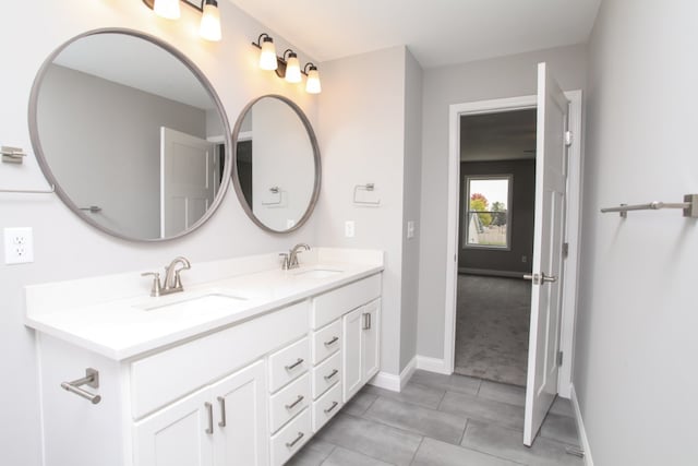 bathroom with tile patterned flooring and dual bowl vanity