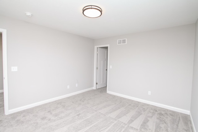 unfurnished room with light colored carpet