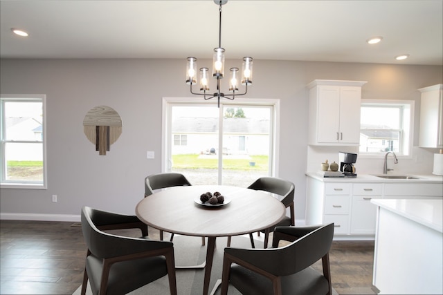 dining space with sink, plenty of natural light, and dark hardwood / wood-style flooring