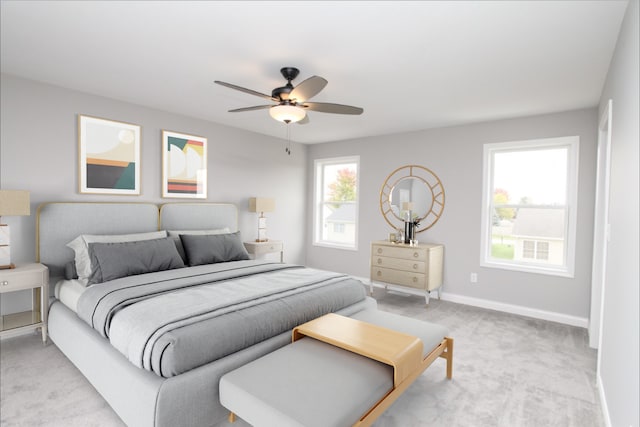 bedroom featuring light colored carpet, multiple windows, and ceiling fan