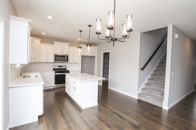 kitchen featuring a kitchen island, stainless steel appliances, dark hardwood / wood-style flooring, and sink