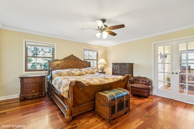 bedroom with multiple windows, dark hardwood / wood-style floors, and french doors