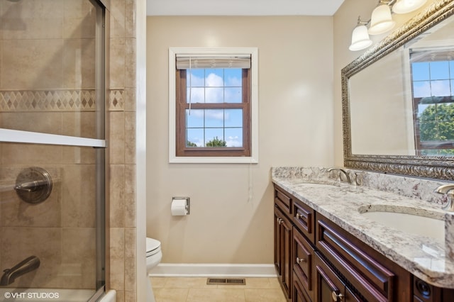 bathroom with tile patterned flooring, vanity, toilet, and plenty of natural light