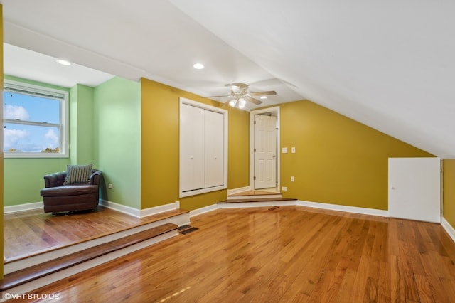 bonus room with vaulted ceiling, ceiling fan, and hardwood / wood-style flooring