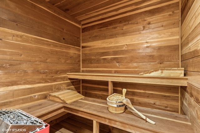 view of sauna / steam room featuring wooden walls and wooden ceiling