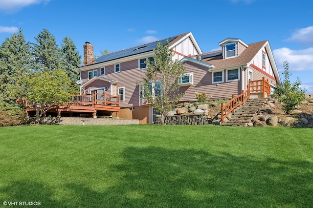 back of house featuring a deck and a yard