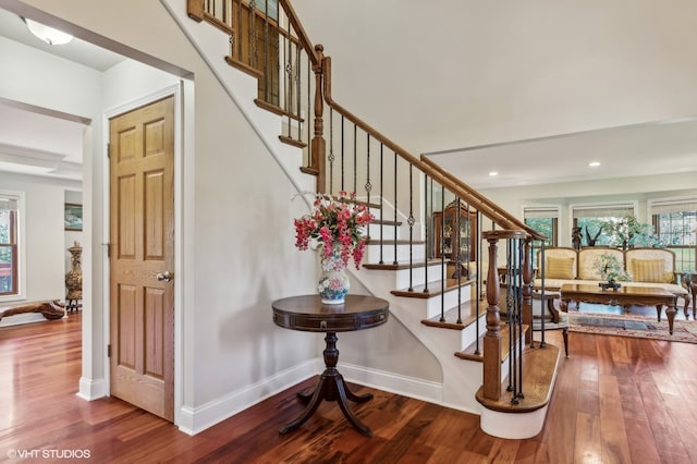 stairway featuring wood-type flooring and beam ceiling