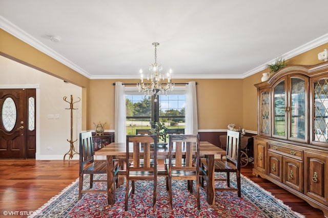 dining area with ornamental molding, dark hardwood / wood-style flooring, and a notable chandelier