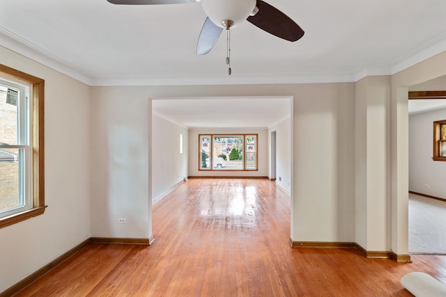 empty room with light hardwood / wood-style flooring, a healthy amount of sunlight, and ceiling fan