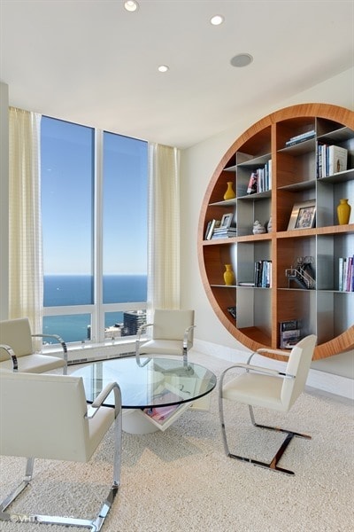 living area with built in shelves and a water view