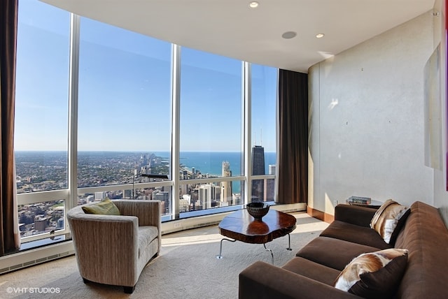 carpeted living room with floor to ceiling windows and a water view