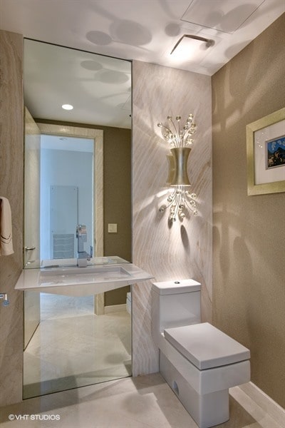 bathroom featuring toilet and concrete flooring