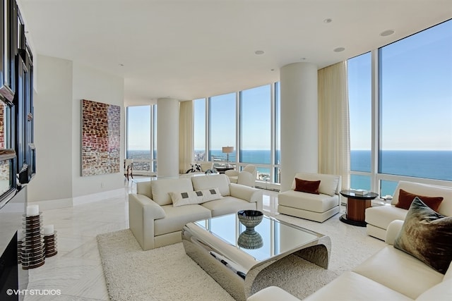 living room with a water view and expansive windows