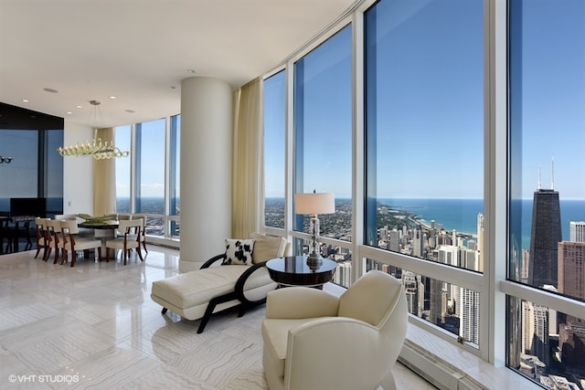 living room with a water view, a chandelier, and a wall of windows