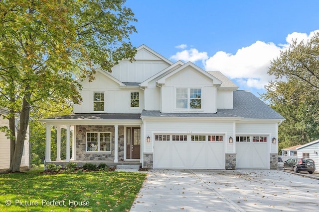 view of front of property featuring a garage and a front lawn