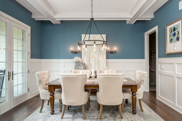 dining area featuring a wealth of natural light, an inviting chandelier, and dark hardwood / wood-style floors