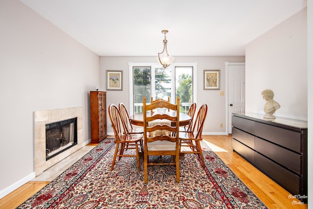 dining area featuring a fireplace and light hardwood / wood-style floors