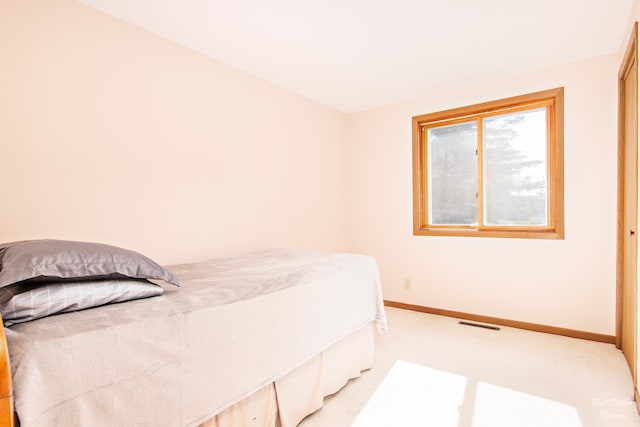 bedroom featuring light colored carpet