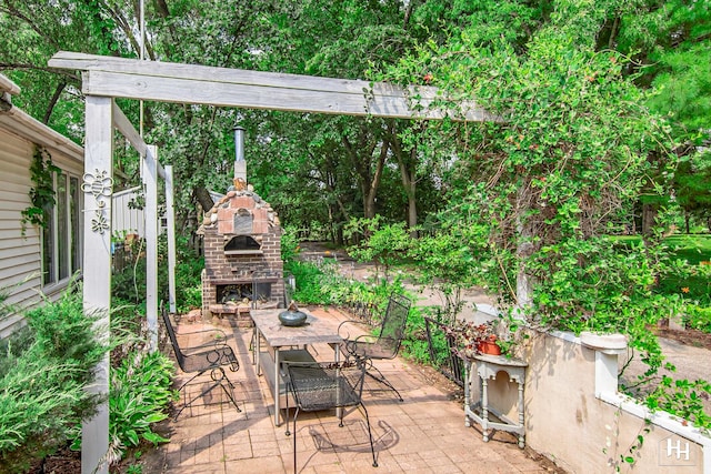 view of patio / terrace with an outdoor brick fireplace