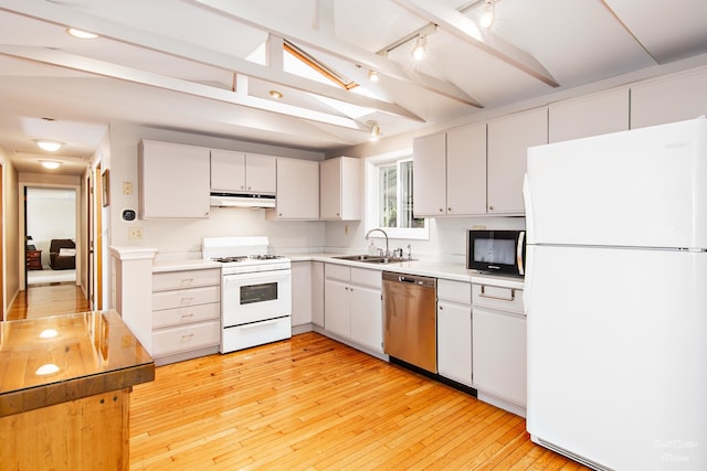 kitchen with white appliances, track lighting, sink, light hardwood / wood-style flooring, and beamed ceiling