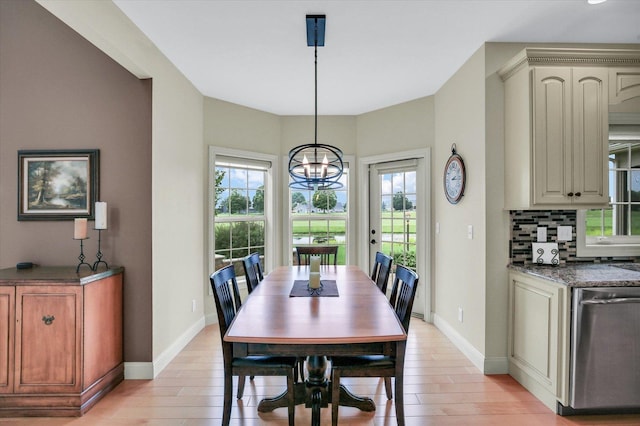 3001 E Stone Creek Blvd, Urbana, IL 61802 - dining room featuring healthy amount of natural light, a chandelier, and light wood-style flooring