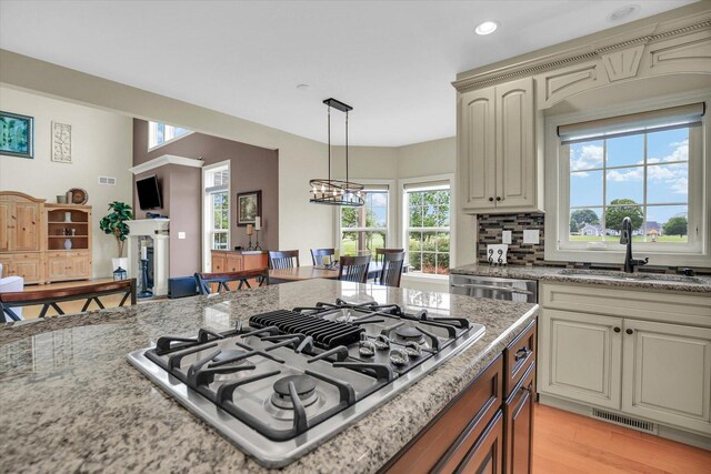 3001 E Stone Creek Blvd, Urbana, IL 61802 - kitchen featuring stovetop with downdraft, light stone countertops, pendant lighting, decorative backsplash, and recessed lighting