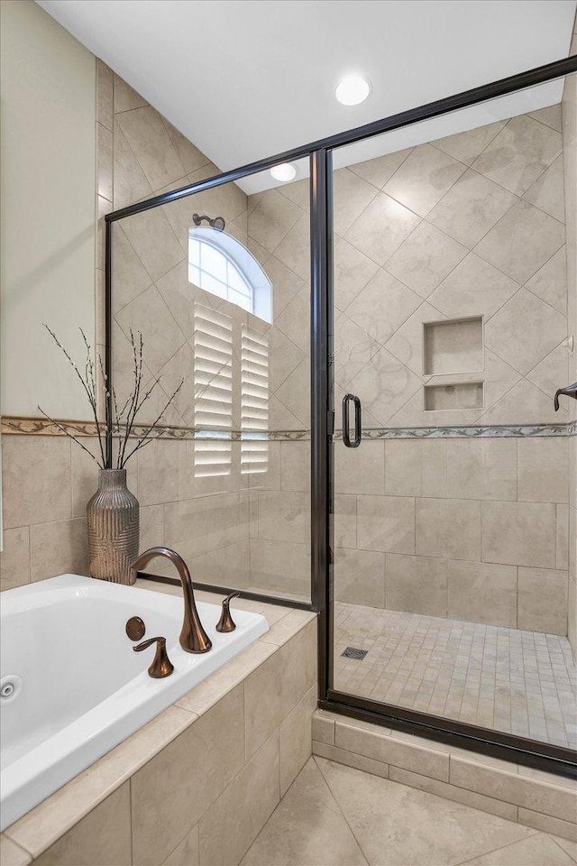 3001 E Stone Creek Blvd, Urbana, IL 61802 - bathroom with a tub with jets, a shower stall, and tile patterned flooring