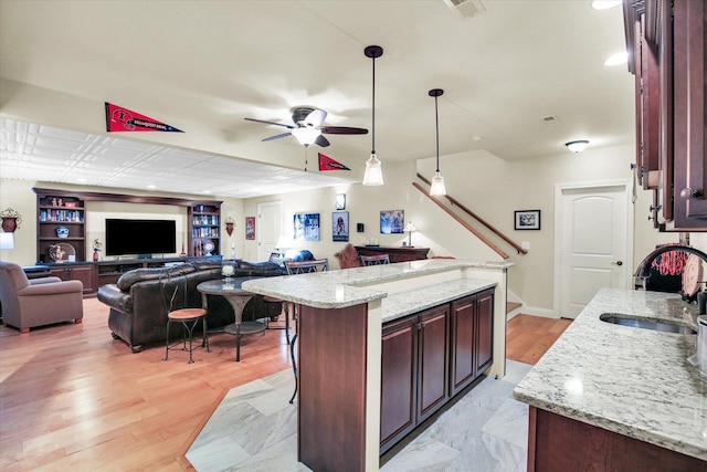 3001 E Stone Creek Blvd, Urbana, IL 61802 - kitchen featuring open floor plan, a ceiling fan, decorative light fixtures, light stone counters, and recessed lighting