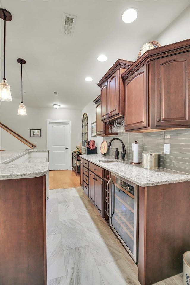 3001 E Stone Creek Blvd, Urbana, IL 61802 - kitchen featuring wine cooler, decorative backsplash, light stone countertops, pendant lighting, and recessed lighting