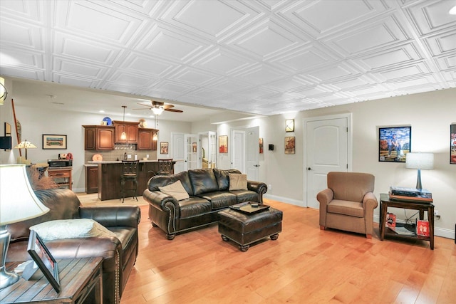 3001 E Stone Creek Blvd, Urbana, IL 61802 - living area with light wood finished floors, ceiling fan, and an ornate ceiling