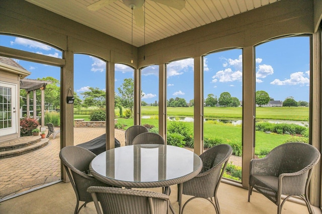 3001 E Stone Creek Blvd, Urbana, IL 61802 - sunroom with a water view, a ceiling fan, outdoor dining area, and golf course view