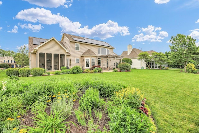 3001 E Stone Creek Blvd, Urbana, IL 61802 - back of house with a pergola, solar panels, a lawn, and a sunroom