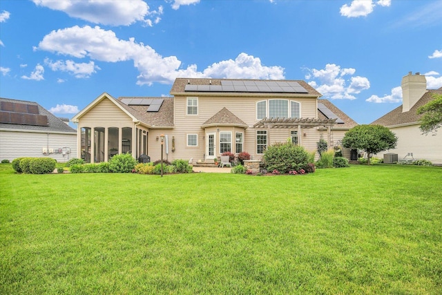 3001 E Stone Creek Blvd, Urbana, IL 61802 - rear view of house with a pergola, solar panels, a patio, a sunroom, and a lawn