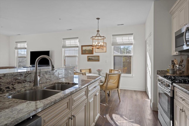33 Johnson Ct Unit 0, North Aurora, IL 60542 - kitchen featuring stainless steel appliances, dark wood finished floors, a chandelier, and healthy amount of natural light