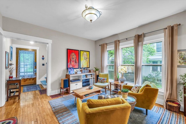 living area with baseboards and light wood-style floors