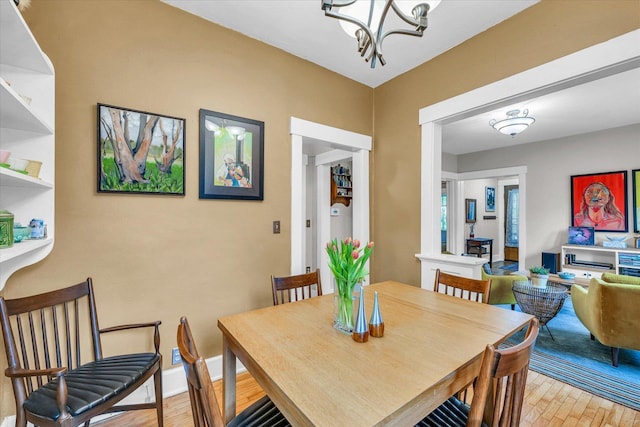 dining area featuring a chandelier and light wood-style flooring