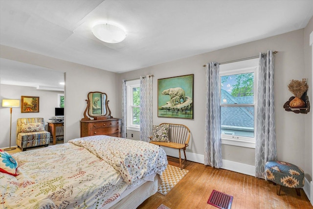 bedroom featuring wood finished floors and baseboards