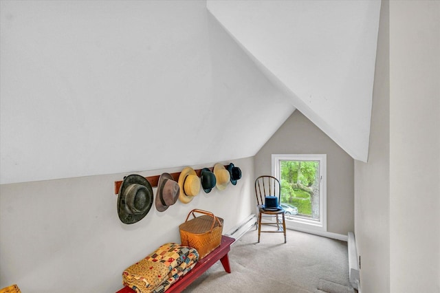 living area with carpet flooring, vaulted ceiling, and a baseboard heating unit