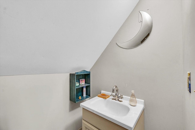 bathroom featuring vanity and vaulted ceiling